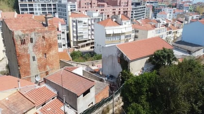 Elevated view of Quinta do Ferro with brick structure and terracotta roofs, São Vicente, Lisbon.