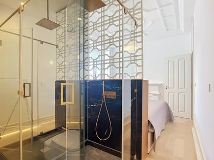 En-suite bathroom with walk-in shower, black marble and decorative lattice screen adjoining the master bedroom