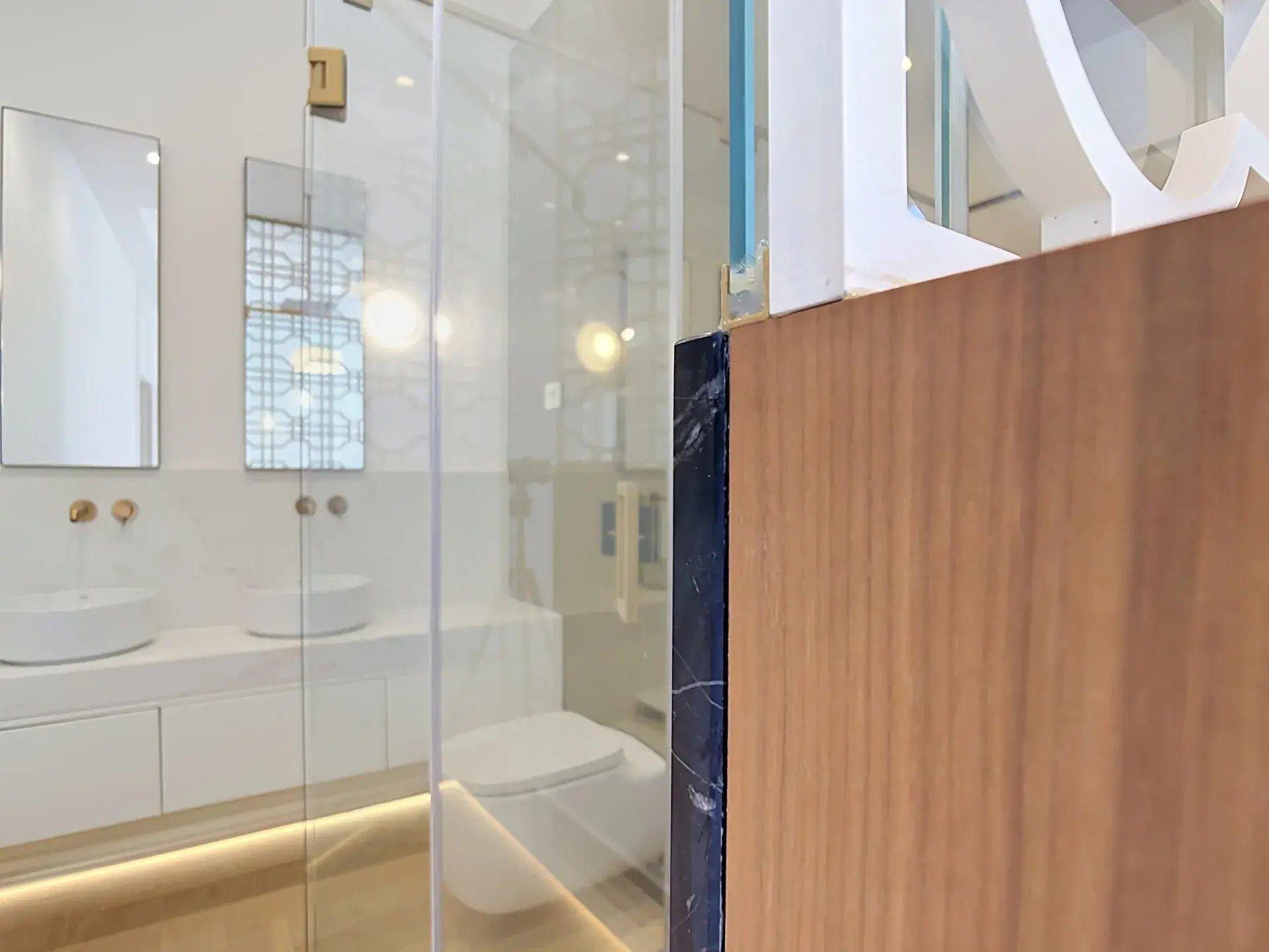 Secondary bathroom with floating double vanity, vessel sinks and brass wall-mounted taps