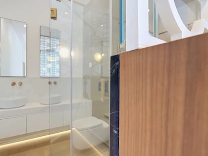 Secondary bathroom with floating double vanity, vessel sinks and brass wall-mounted taps