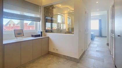 Gallery with a window seat, looking through to a bedroom in the penthouse