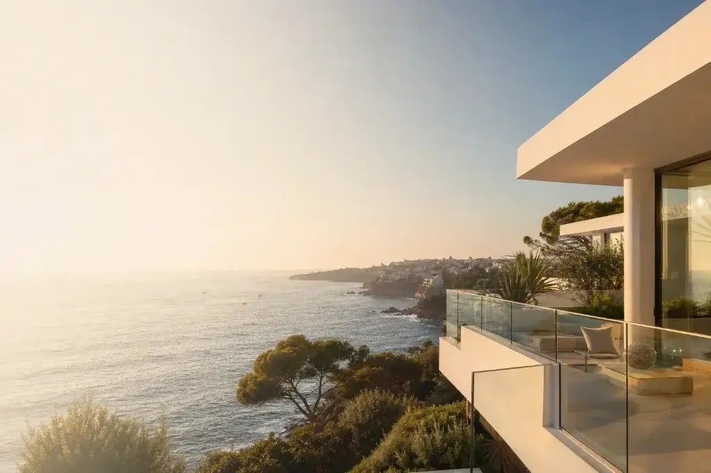 Premium coastal villa in Portugal at golden hour — white terrace, infinity pool and Atlantic views, Cavalcanti RealEstate Team